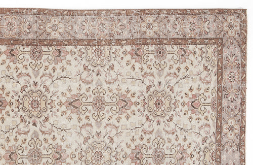 Load image 1 in gallery view. Beige and brown traditional rug with a distressed floral medallion pattern and a decorative border.