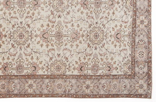 Load image 1 in gallery view. Beige and muted rose vintage-style rug with a distressed floral medallion pattern and a decorative border.