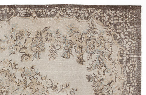 Load image 1 in gallery view. Beige and brown vintage-style rug with a floral medallion pattern and distressed texture on a white background.