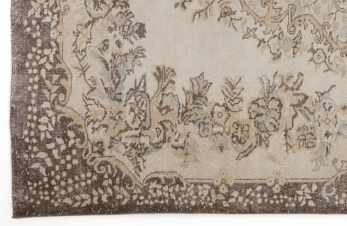 Load image 1 in gallery view. Beige and dark brown rug with a distressed floral medallion pattern and intricate border detail.