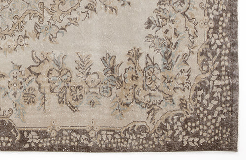 Load image 1 in gallery view. Beige and brown traditional rug with a distressed floral medallion pattern and a dark border.
