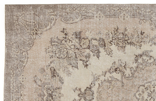 Load image 1 in gallery view. Taupe and beige vintage-style rug with a distressed floral medallion pattern.
