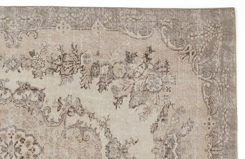 Load image 1 in gallery view. Taupe and beige distressed rug with a faded traditional floral medallion pattern.