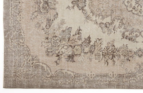 Load image 1 in gallery view. Beige and taupe distressed rug with a faded floral medallion pattern.