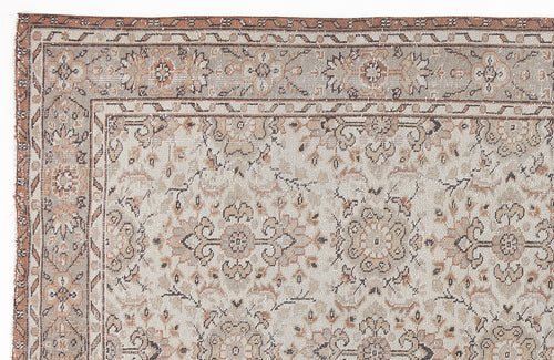 Load image 1 in gallery view. Beige and terracotta traditional rug with a distressed floral medallion pattern and a geometric border.
