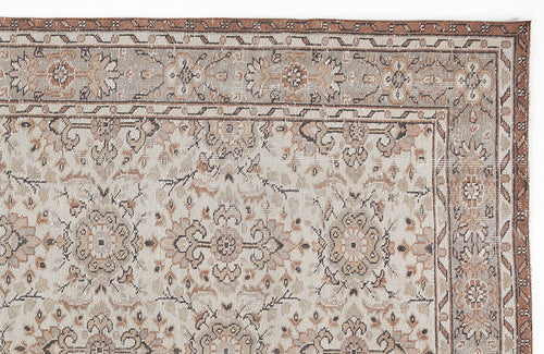 Load image 1 in gallery view. Beige and brown traditional rug with a distressed floral medallion pattern and a geometric border.