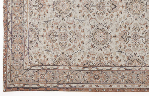 Load image 1 in gallery view. Beige and brown traditional rug with a distressed floral medallion pattern and a geometric border.