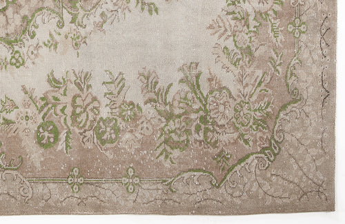 Load image 1 in gallery view. Distressed beige and cream rug with a faded green floral medallion pattern.