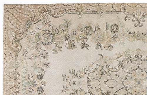 Load image 1 in gallery view. Beige and tan vintage-style rug with a distressed floral medallion pattern in muted green and charcoal accents.