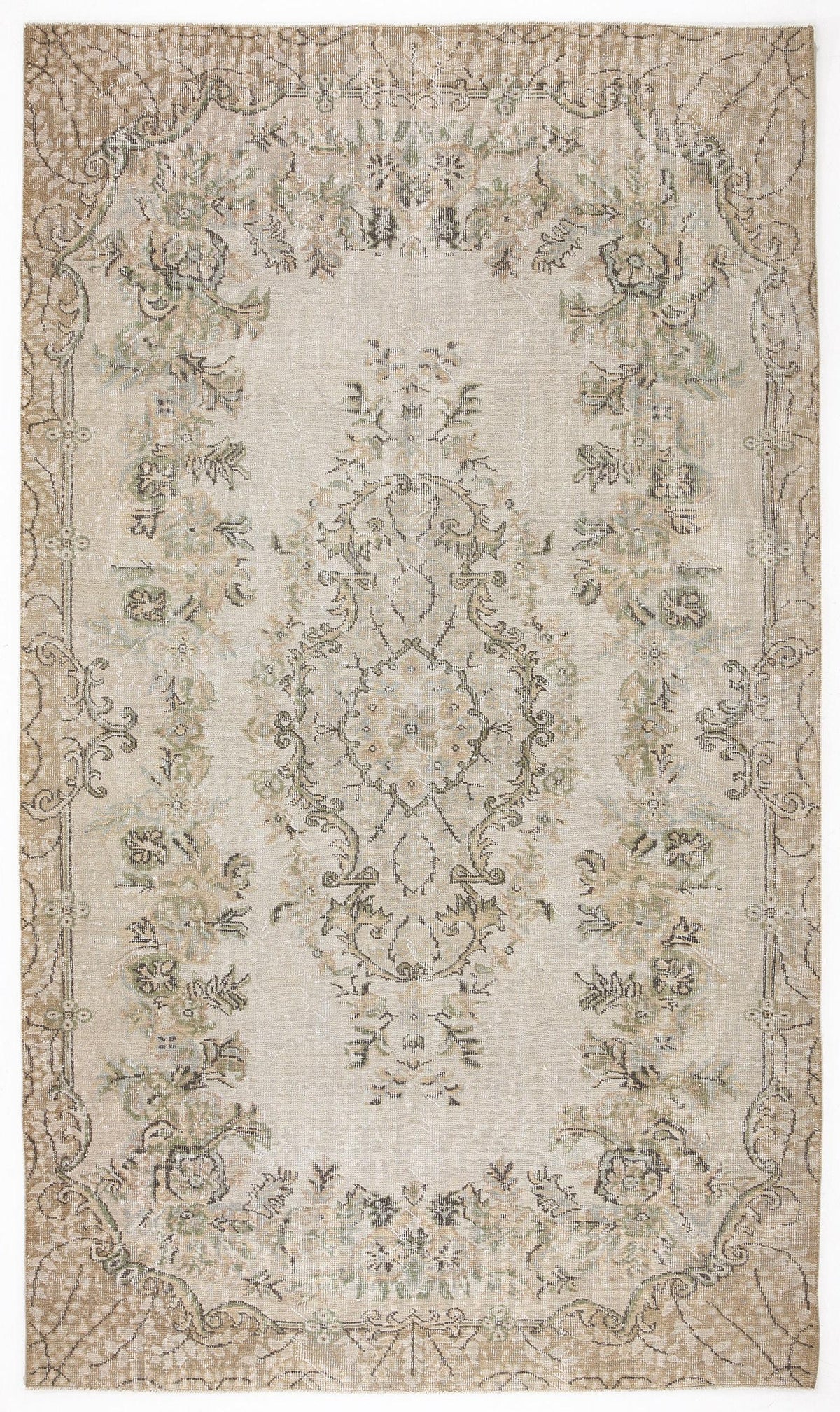 Beige and cream distressed rug with a central floral medallion and ornate border in muted sage and brown tones.