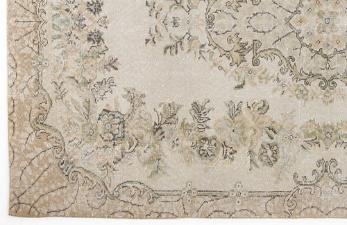 Load image 1 in gallery view. Beige and cream vintage-style rug with a distressed floral medallion pattern and muted green and brown accents.