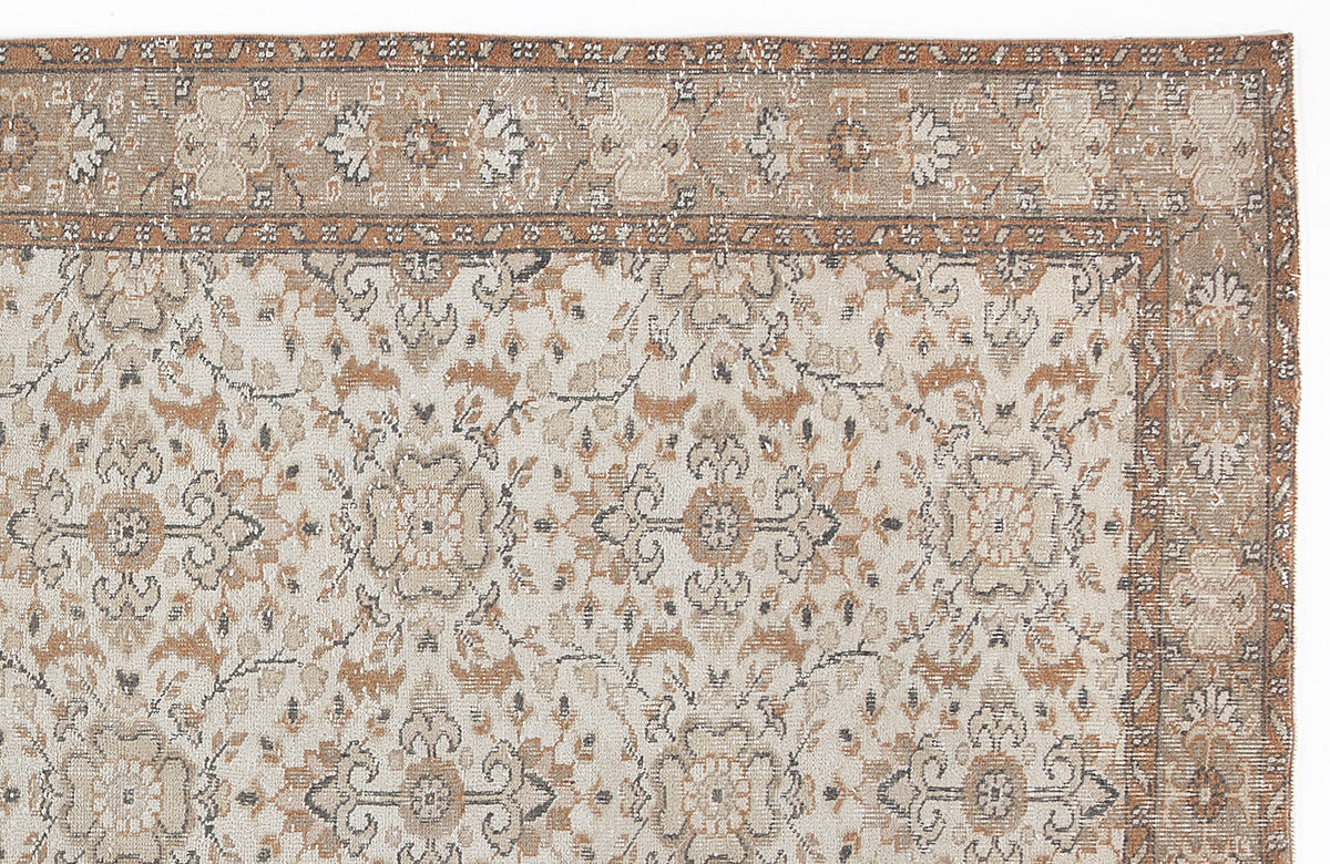 Beige and rust-colored traditional rug with a distressed floral medallion pattern and a decorative border.