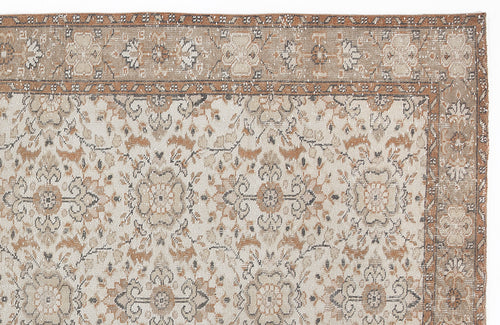 Load image 1 in gallery view. Beige and rust-colored traditional rug with a distressed floral medallion pattern and a decorative border.