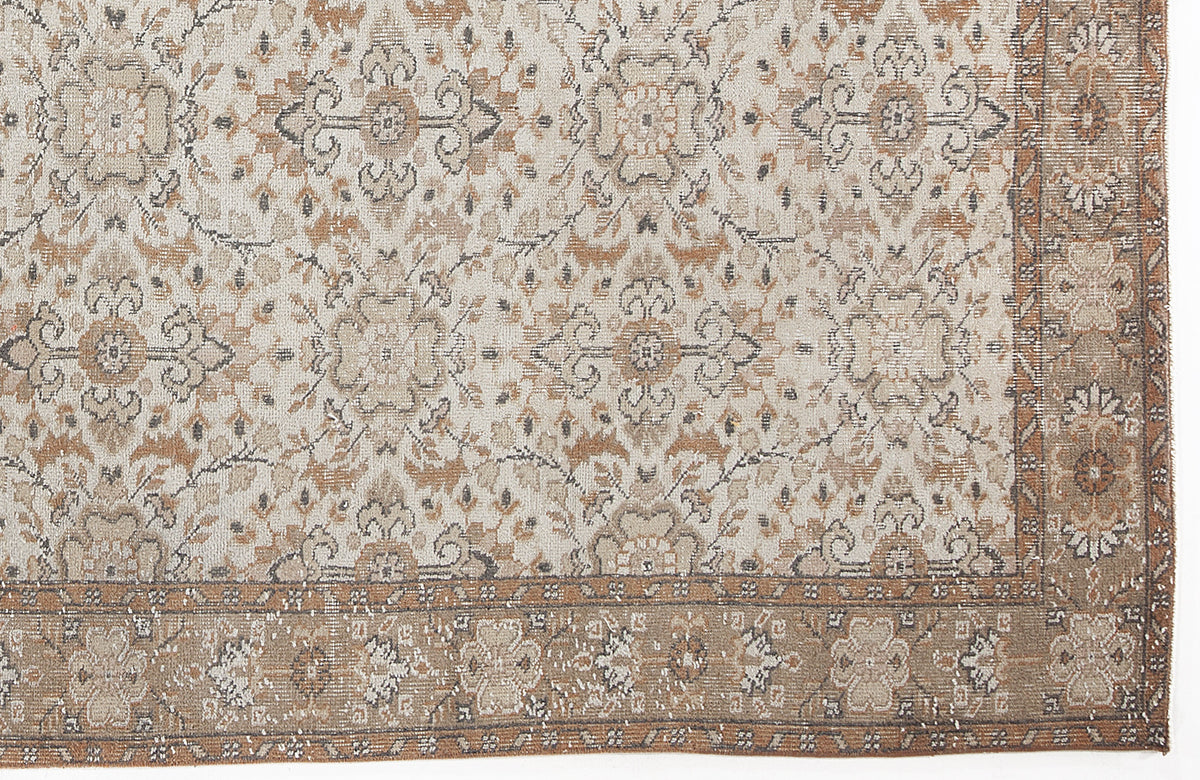 Beige and brown rug with a distressed traditional floral medallion pattern and a wide decorative border.