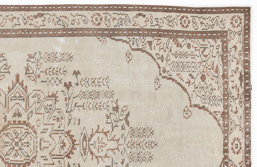 Load image 1 in gallery view. Beige and brown traditional rug with a distressed medallion pattern and ornate border.