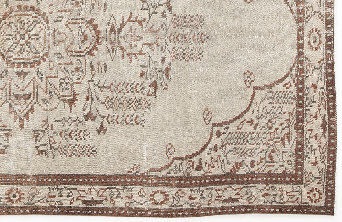 Beige and rust-colored traditional rug with a distressed medallion pattern and a geometric border.
