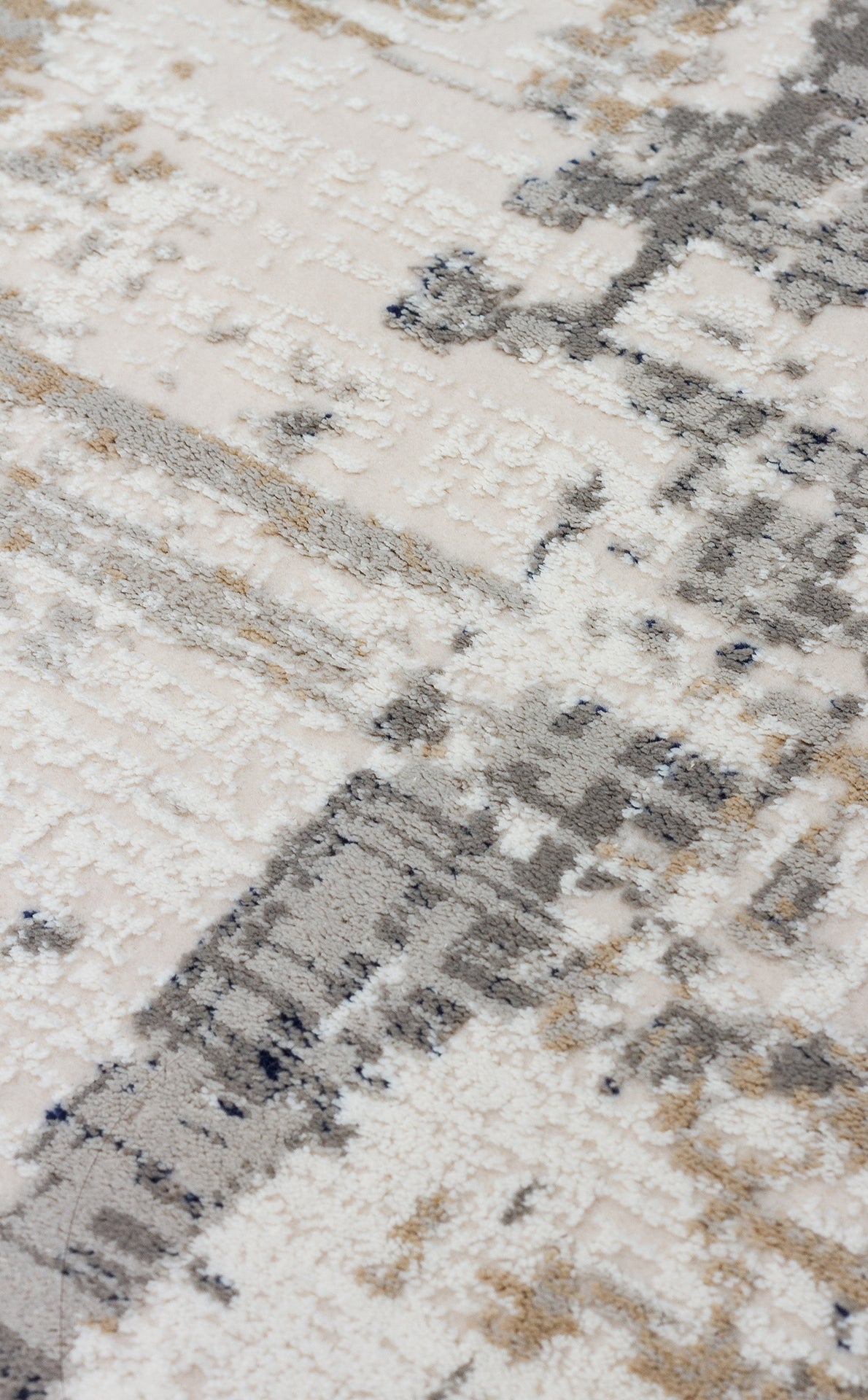 Cream, grey, and beige rug with a high-low pile texture and an abstract, distressed geometric pattern.