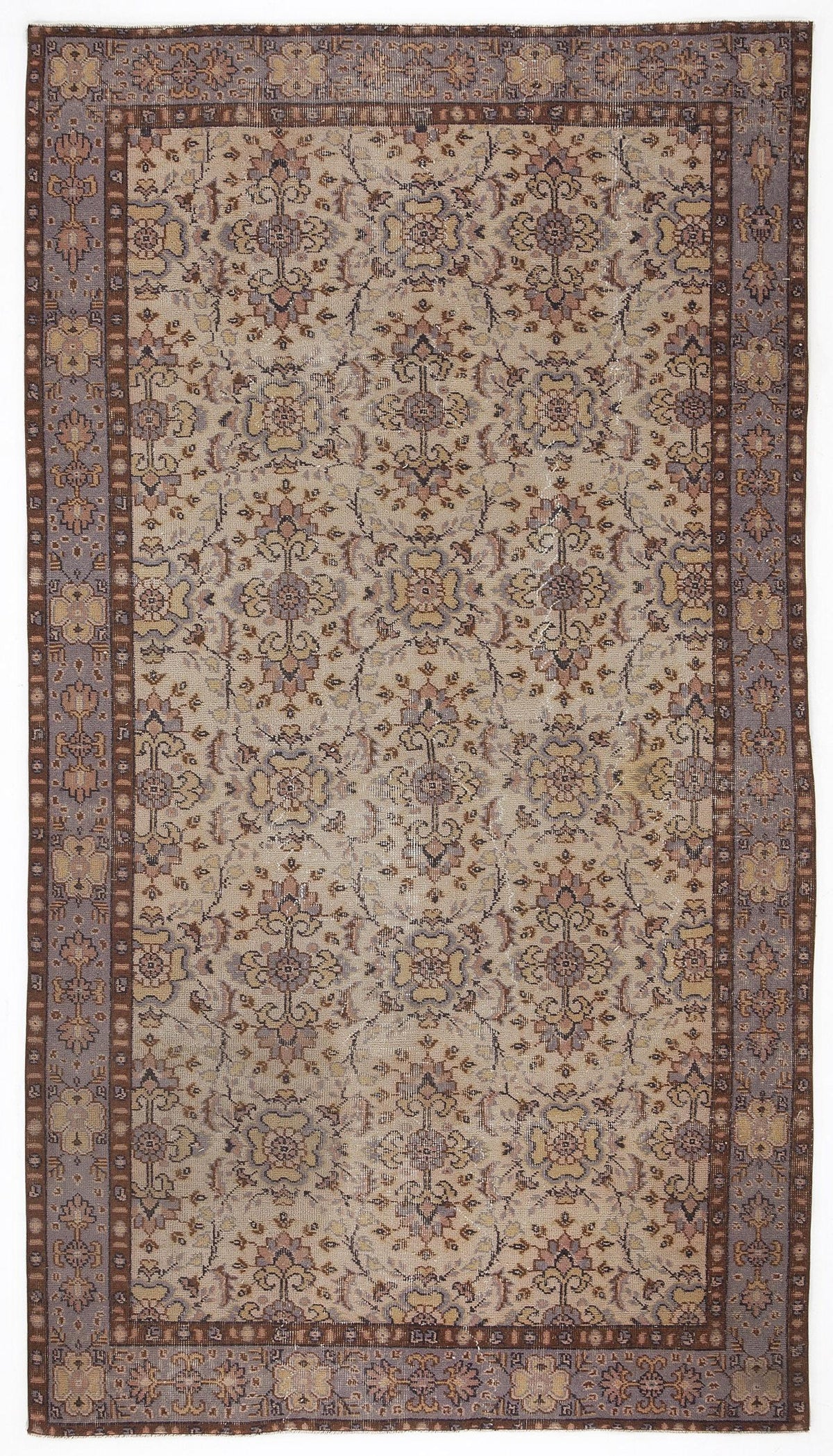 Distressed beige, mauve, and brown rug with a traditional floral medallion pattern and a wide decorative border.