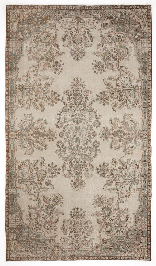 Load image 1 in gallery view. Beige traditional rug with a distressed floral medallion pattern in muted brown, sage green, and soft pink tones.