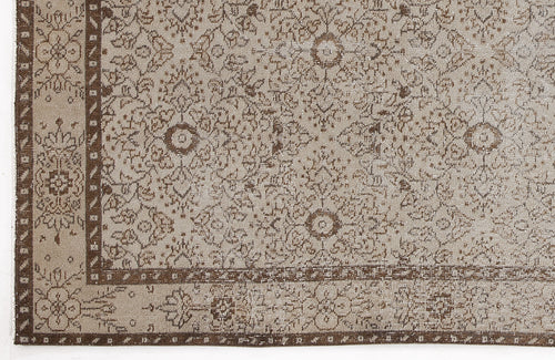 Load image 1 in gallery view. Beige and brown traditional rug with a distressed floral medallion pattern and a geometric border.