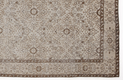 Load image 1 in gallery view. Beige and brown rug with a distressed traditional floral medallion pattern and a decorative border.