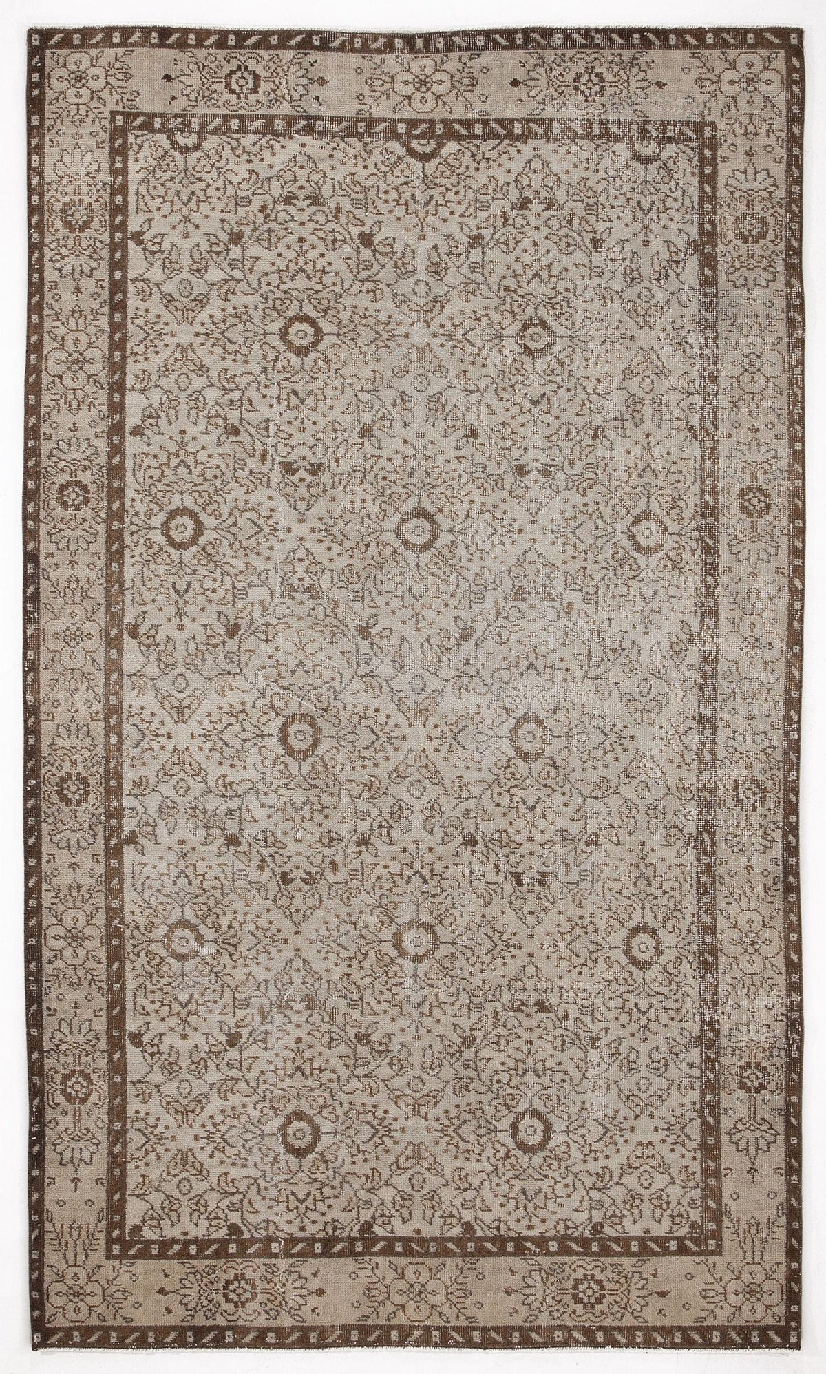 Beige and brown traditional rug with a distressed floral medallion pattern and a wide decorative border.