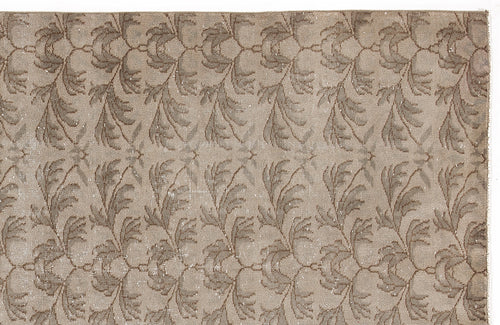 Load image 1 in gallery view. Taupe and beige rug with a repeating distressed floral vine pattern.
