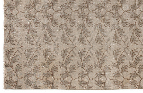 Load image 1 in gallery view. Taupe and beige rug with a repeating distressed botanical leaf pattern.