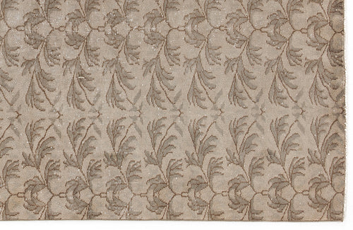 Load image 1 in gallery view. Taupe and beige rug featuring a repeating vertical botanical leaf pattern with a distressed texture.