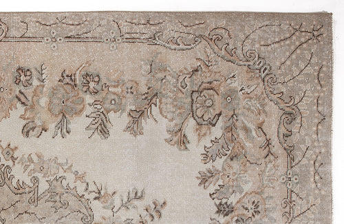 Load image 1 in gallery view. Taupe and beige rug with a distressed floral medallion pattern and ornate border on a white background.