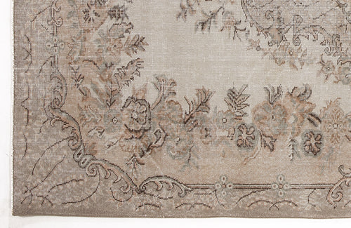 Load image 1 in gallery view. Beige and taupe vintage-style rug with a distressed floral medallion pattern and ornate border.