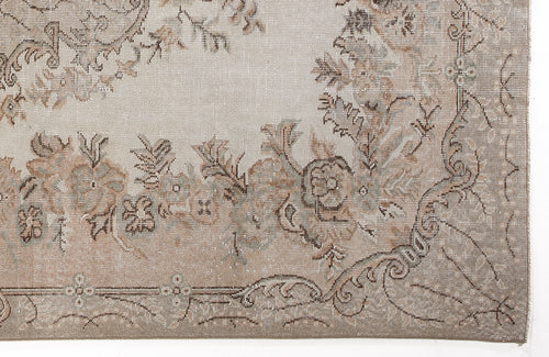 Load image 1 in gallery view. Beige and taupe vintage-style rug with a faded floral medallion pattern and ornate border.