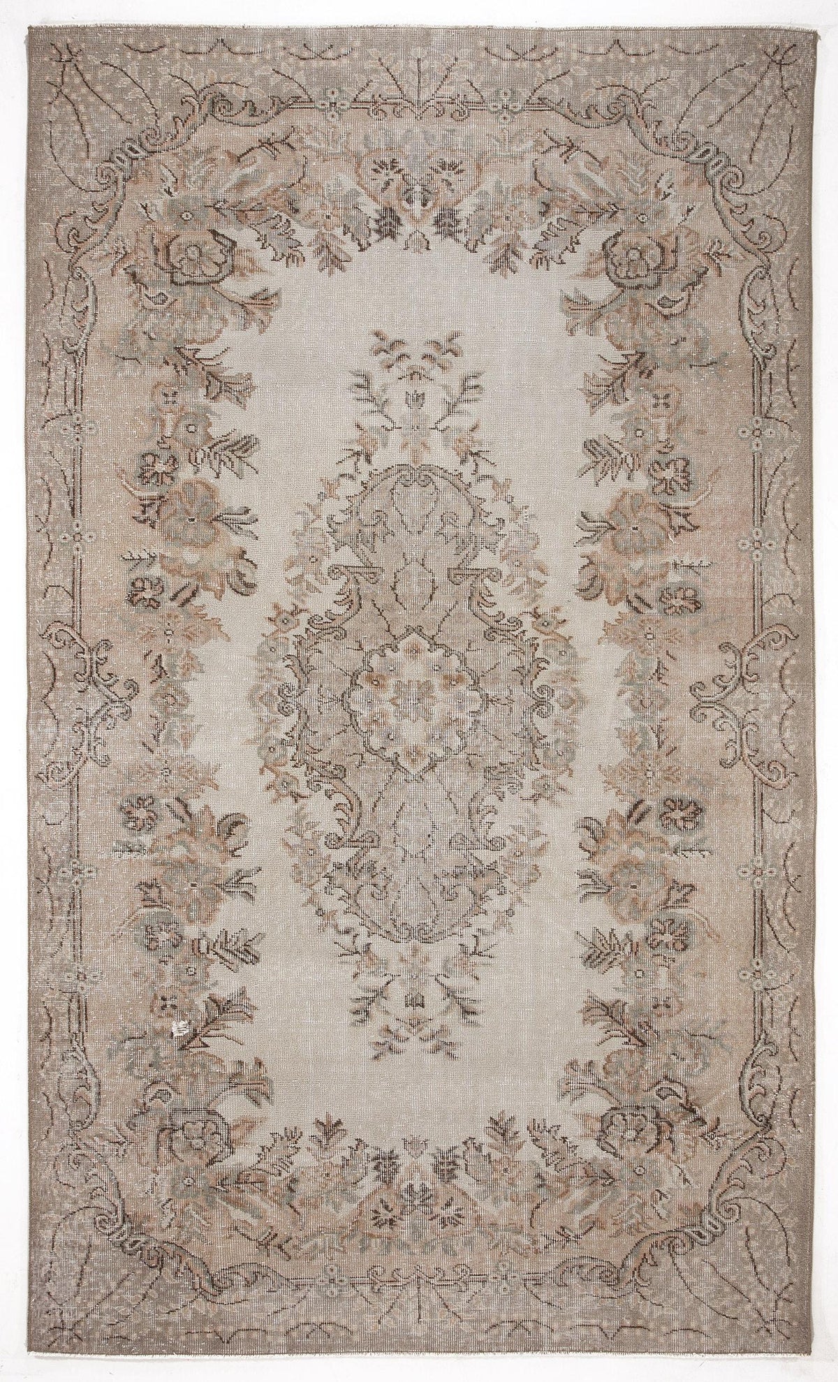 Beige and taupe vintage-style rug with a central floral medallion and ornate border on a white background.