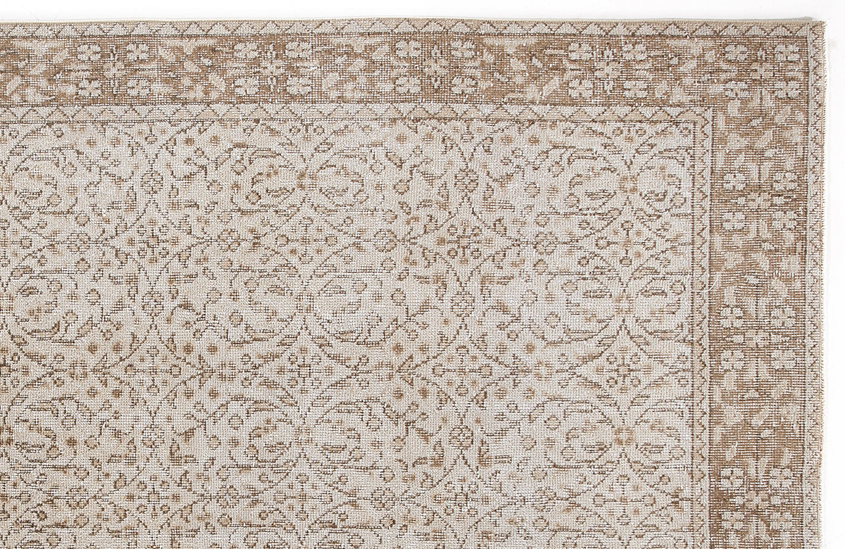 Beige and cream rug with a traditional floral medallion pattern and a detailed botanical border.