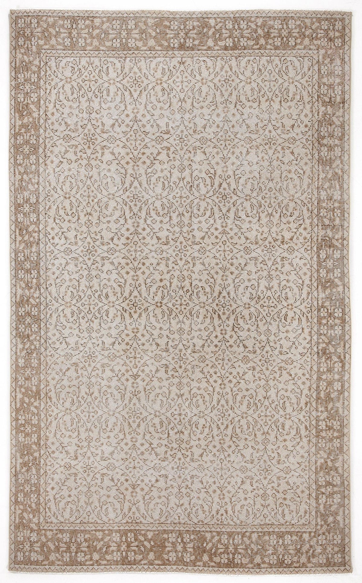 Beige and cream traditional rug with a distressed floral medallion pattern and a wide decorative border.