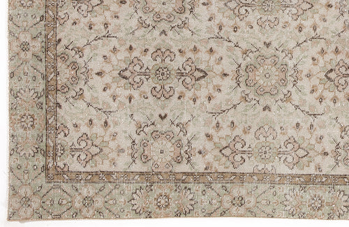 Load image 1 in gallery view. Beige, sage green, and brown traditional rug with a distressed floral medallion pattern and a decorative border.