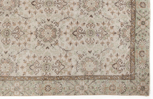 Load image 1 in gallery view. Beige and sage green rug with a distressed traditional floral medallion pattern and a decorative border.