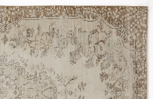 Load image 1 in gallery view. Beige and brown distressed rug with a faded traditional floral medallion pattern on a white background.