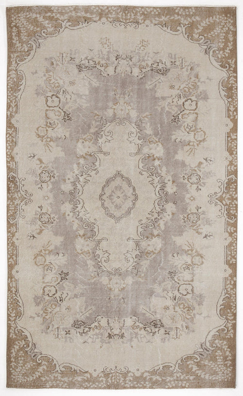 Load image 1 in gallery view. Taupe and cream distressed traditional rug with a central floral medallion and ornate border.