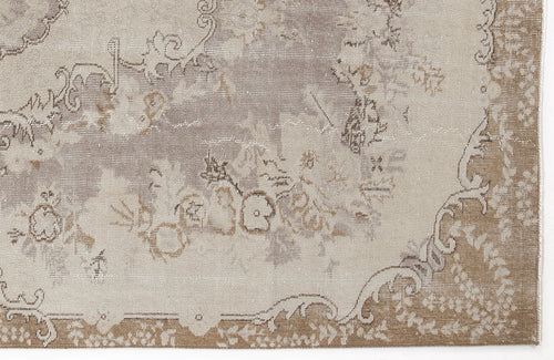Load image 1 in gallery view. Taupe and beige distressed rug with a faded traditional floral medallion pattern.
