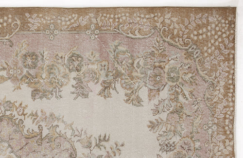 Load image 1 in gallery view. Distressed beige and dusty pink rug with a faded floral medallion pattern and ornate border.