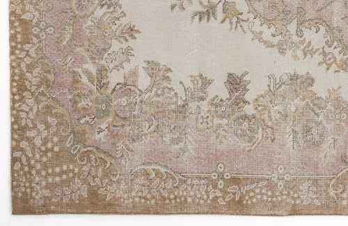 Load image 1 in gallery view. Distressed beige, tan, and muted pink rug with a traditional floral medallion pattern.