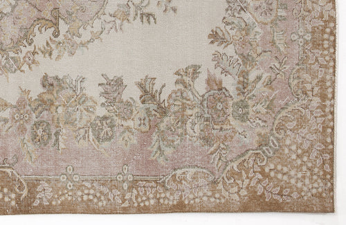 Load image 1 in gallery view. Distressed beige and dusty rose rug with a traditional floral medallion pattern and a wide brown border.