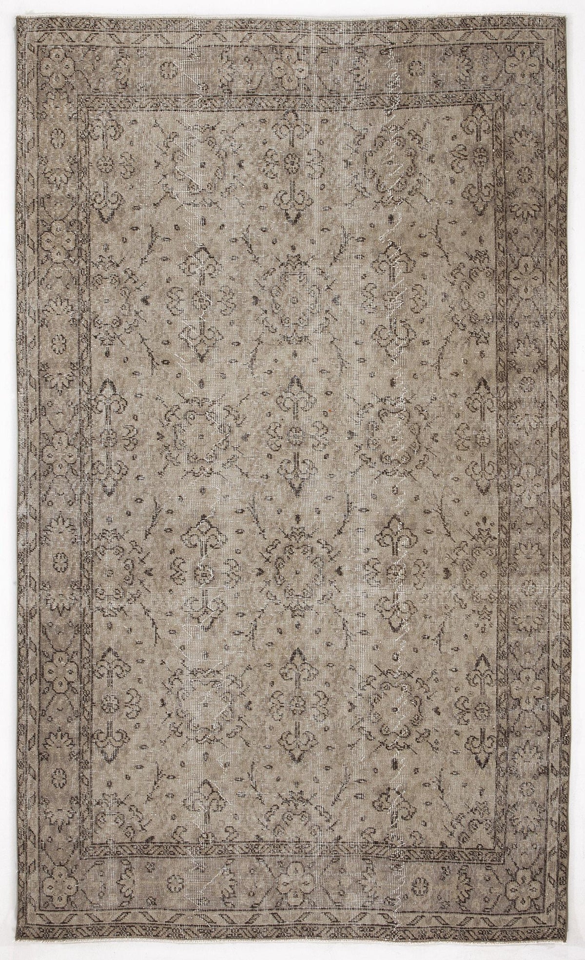 Taupe and charcoal distressed rug with a traditional floral medallion pattern and a decorative border.