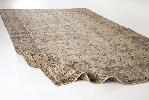 Load image 1 in gallery view. Beige and brown distressed traditional rug with a faded floral medallion pattern on a white background.