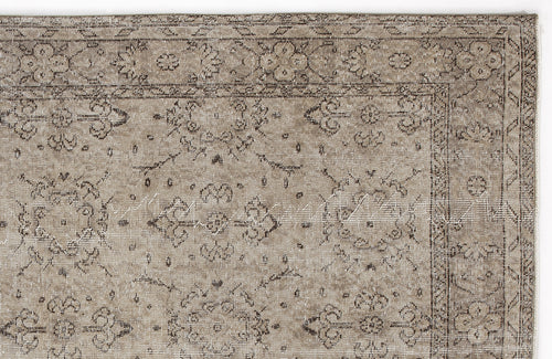 Load image 1 in gallery view. Taupe and charcoal distressed rug with a traditional floral medallion border and central motif.