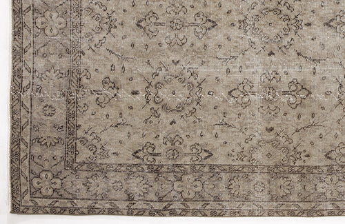 Load image 1 in gallery view. Taupe and dark brown distressed rug with a traditional floral medallion pattern and a geometric border.