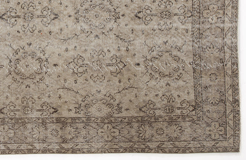 Load image 1 in gallery view. Taupe and brown distressed rug with a traditional floral medallion pattern and a detailed border.