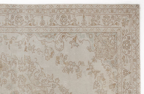 Load image 1 in gallery view. Beige and taupe traditional rug with a faded floral medallion pattern and a detailed geometric border.