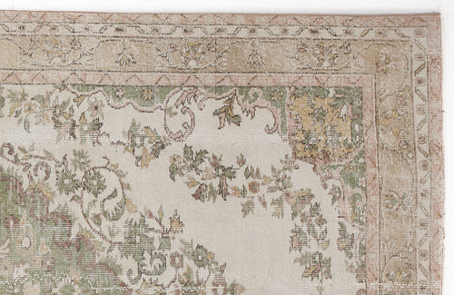 Load image 1 in gallery view. Beige rug with a muted green, pink, and tan floral border and central medallion pattern on a cream background.